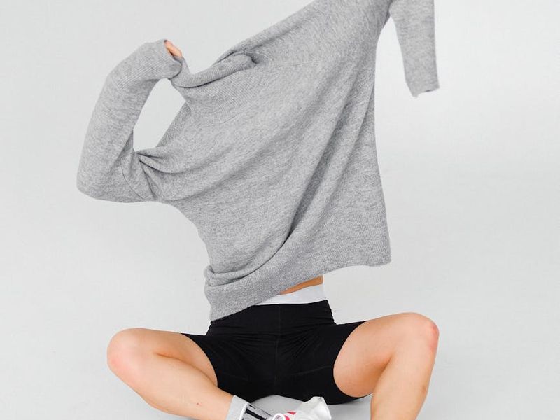 Person doing dynamic movements in a bright airy studio space.