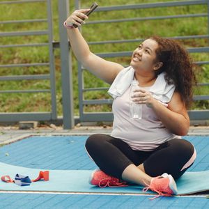 Water bottle and towel on a clean exercise mat.